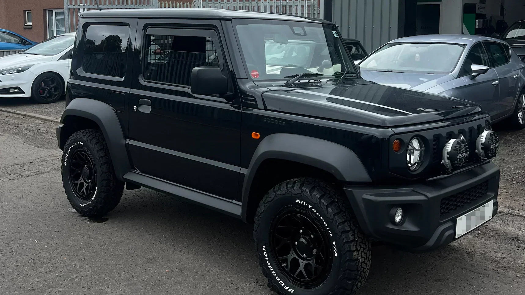 Black Suzuki Jimny (2018+) with 16" Magpie M-01 wheels in Satin Black and IPF 950 Super Rally LED Spot & Driving Hybrid Lamps